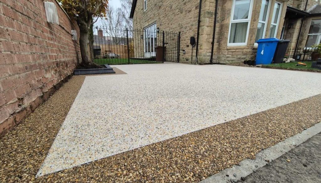 Resin driveway beside a stone-built home
