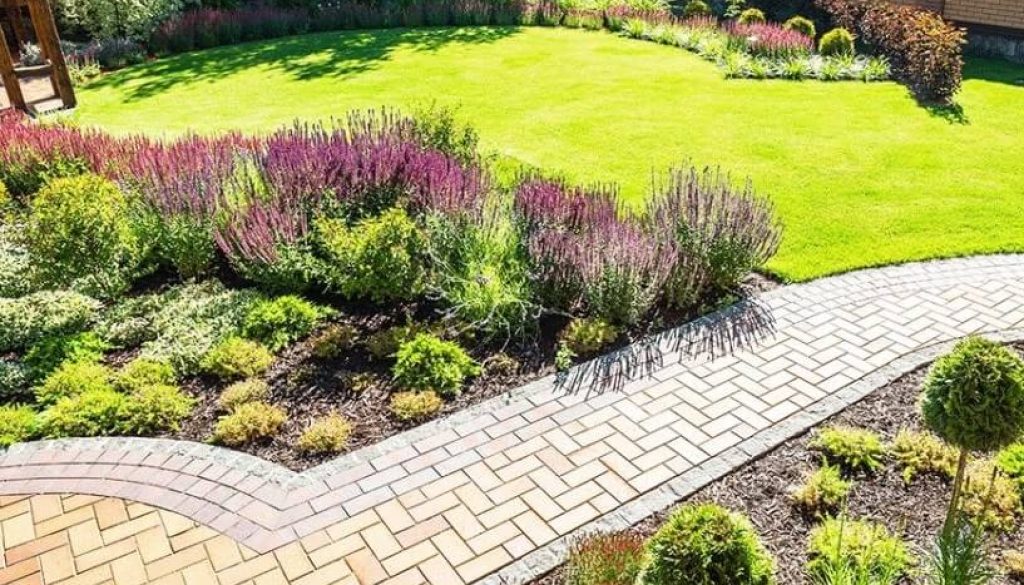 Modern garden design with paved patio and seating area in Newcastle