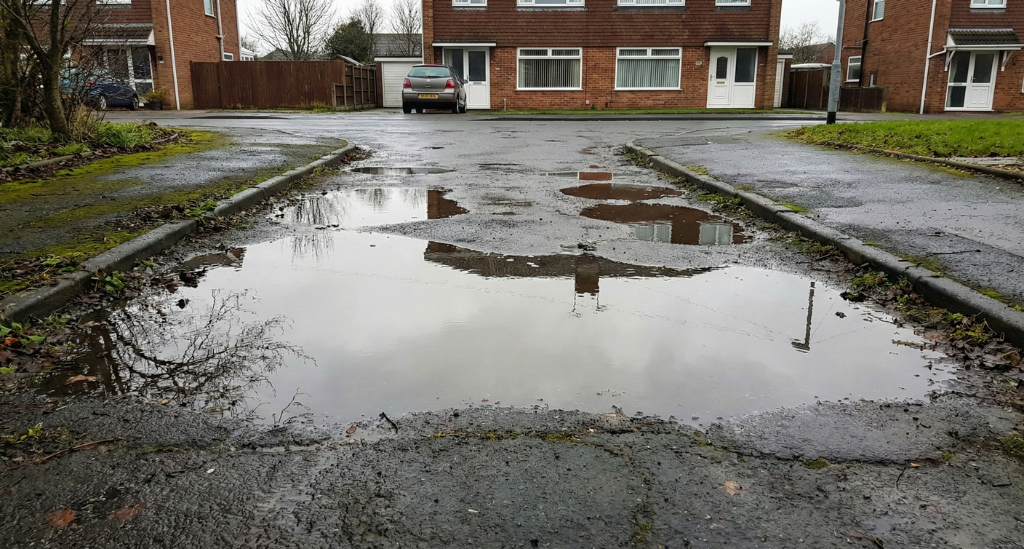 Standing water after heavy rain is a clear sign that driveway drainage is failing and moisture is building beneath the surface.