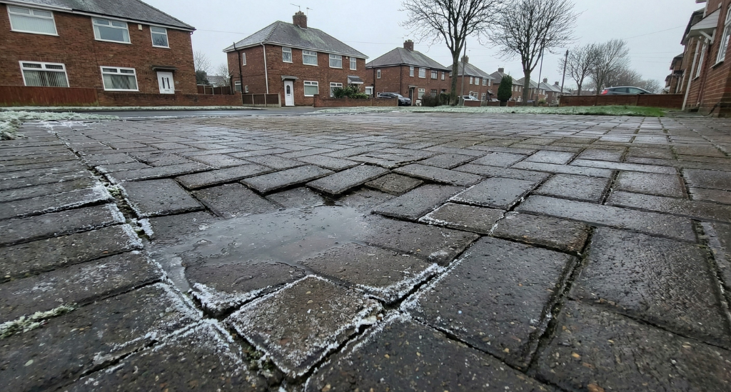 Subtle sinking during winter often signals base movement caused by moisture saturation and freeze–thaw pressure beneath the surface.