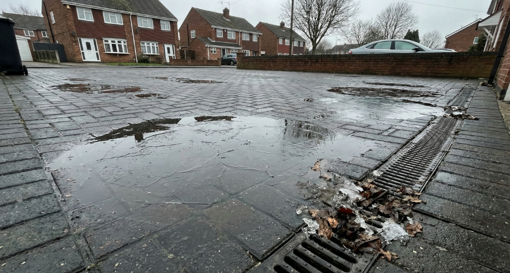 Persistent standing water increases freeze–thaw damage, allowing moisture to penetrate and weaken driveway surfaces throughout winter.