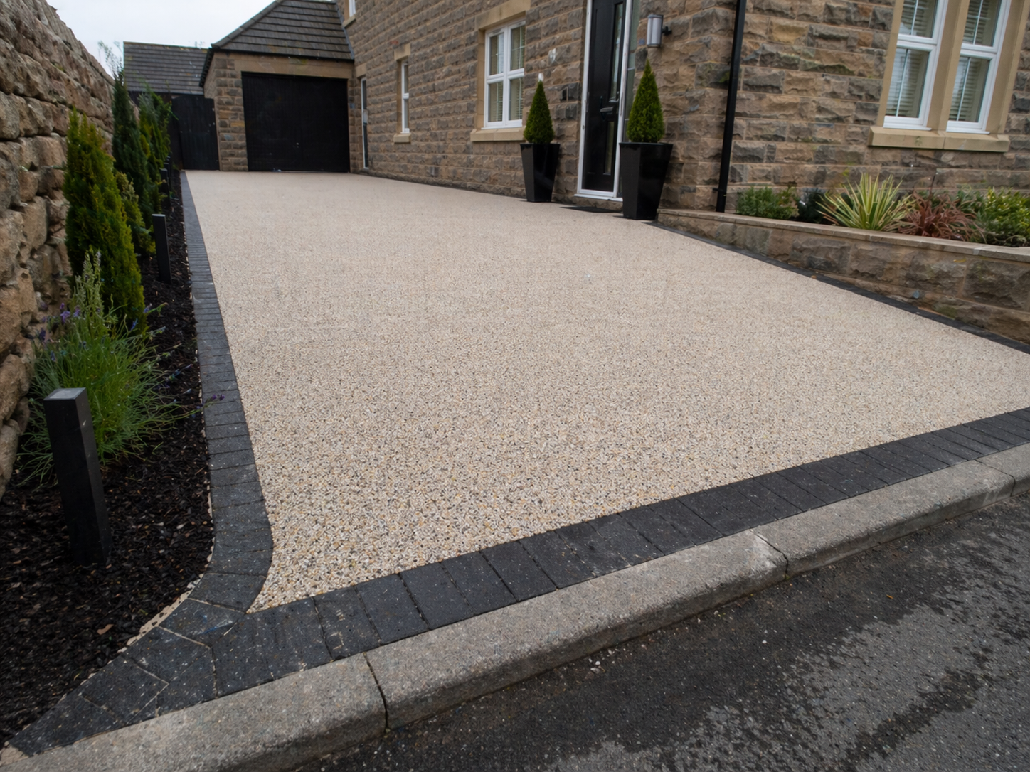 Modern stone house with resin driveway