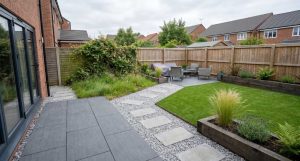 Newly installed garden patio with unkempt grass on the left