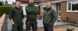 Driveway contractors in front of a driveway installation