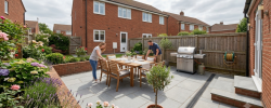 Homeowner checking a paved patio prepared for a summer BBQ and guests
