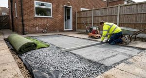 Compacted aggregate base and weed membrane prepared before laying artificial grass