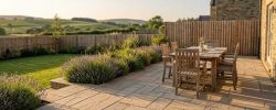 Indian sandstone patio with dining table in a Northumberland garden in summer