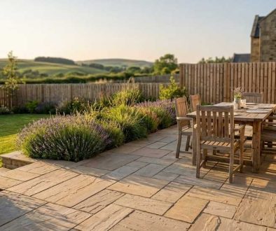 Indian sandstone patio with dining table in a Northumberland garden in summer