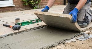 Sandstone slab being bedded onto a full mortar bed with cement slurry primer