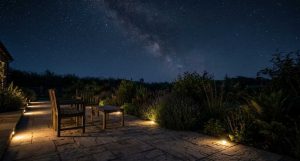 Warm low-level lights along the edge of a patio under a dark Northumberland sky