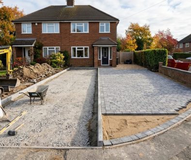 Driveway installation in progress with excavated sub-base beside finished block paving