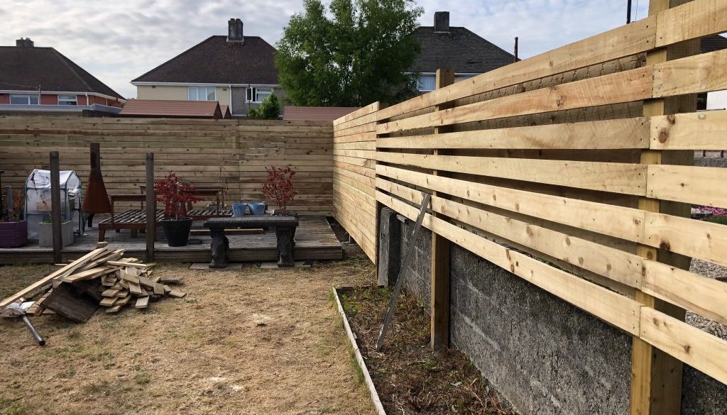 Timber boundary fencing during garden work