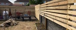 Timber boundary fencing during garden work