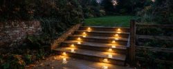 Lit sandstone garden steps at dusk in a Newcastle garden