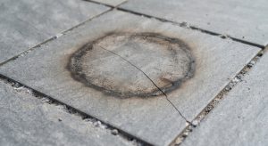 Porcelain patio slab cracked and scorched by fire pit heat