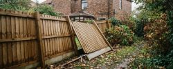 Leaning timber fence panel in a Northumberland garden after an autumn storm
