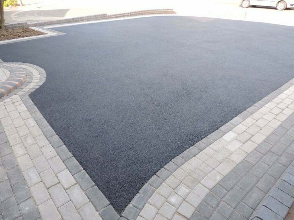 Finished tarmac driveway framed by contrasting block paving borders