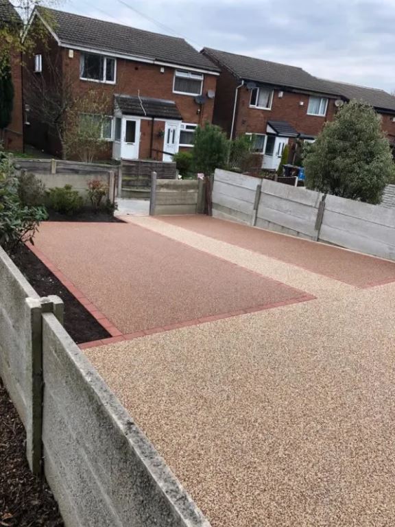 Two-tone resin bound driveway with brick edging and pale stone paths