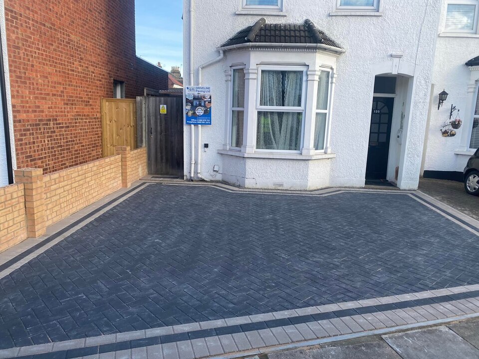 Charcoal herringbone block paving with light borders