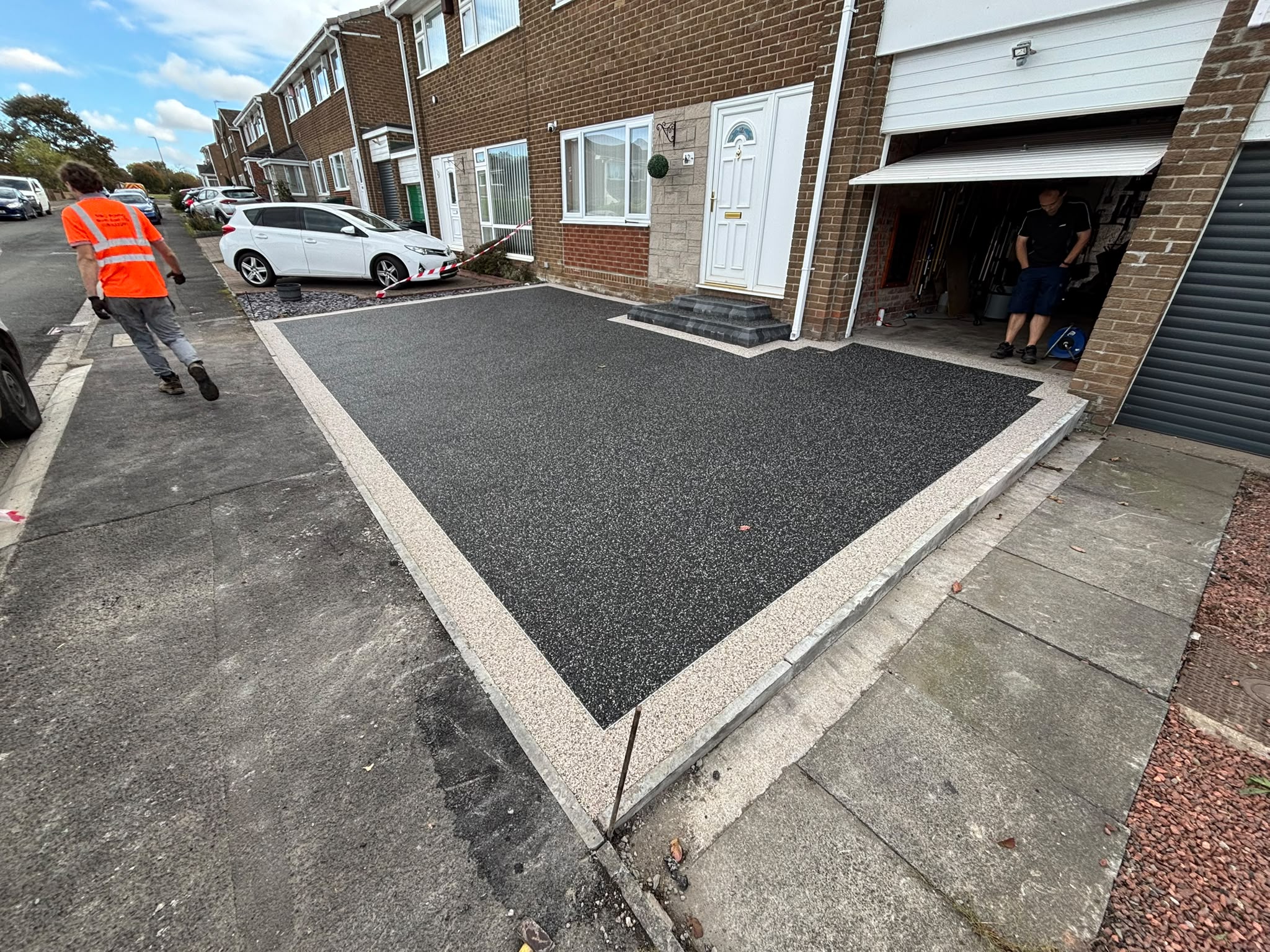 Wide view of the new charcoal resin driveway installation